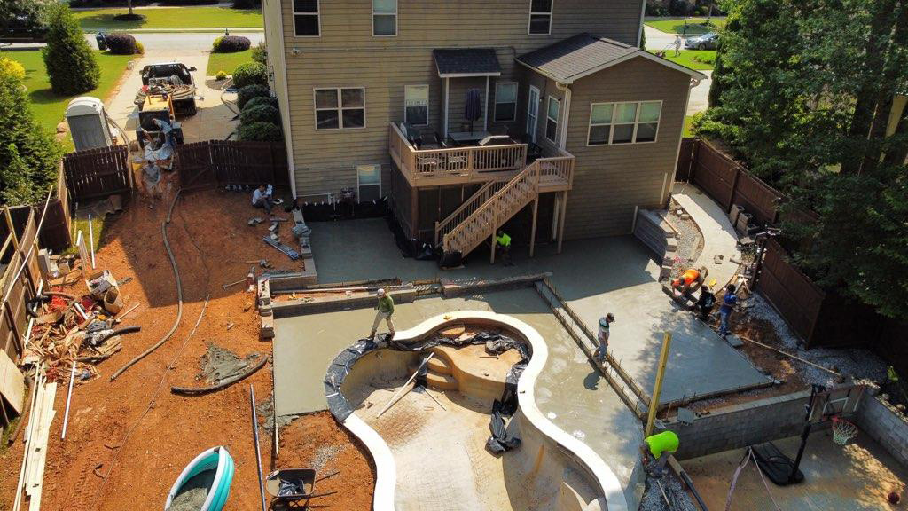 Rock Creek Concrete Pumping providing concrete to a backyard pool construction